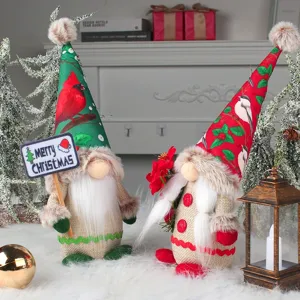 Pair of festive Christmas gnomes with printed hats and Merry Christmas sign decor