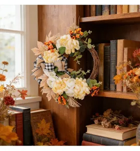 Autumn artificial floral wreath with plaid bow and berries for front door home decor.