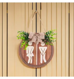 Rustikales WC-Schild aus Holz mit lustigen Silhouetten und künstlicher Pflanzendekoration