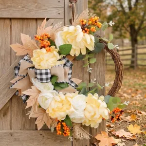 Autumn artificial flower wreath with yellow and white blooms berries and plaid bow for front door decor
