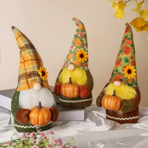Set of three autumn plush gnomes with sunflower hats holding pumpkins for home decor
