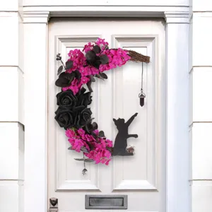 Hand-crafted crescent moon wreath with black roses, pink flowers, and cat silhouette