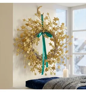 Elegant golden glitter star wreath with a green ribbon hanging in a cozy winter room setting.