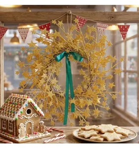 Close-up of a festive golden glitter star wreath with a green ribbon hanging on a window