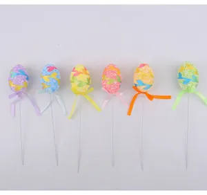 Six colorful foam Easter egg picks with vine patterns and ribbons for holiday decor.
