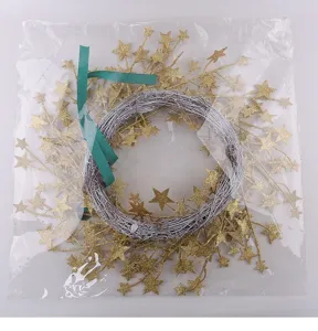 Detail of golden glitter star rattan wreath holiday decoration in clear plastic packaging bag