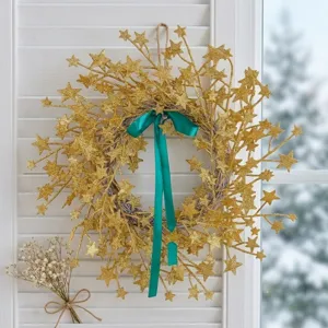 Elegant gold glitter star rattan wreath with a vibrant green ribbon bow for festive decor