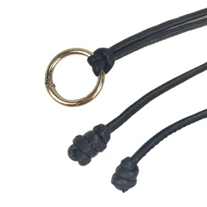 Detailed view of a minimalist black PU knotted waist belt with a golden metal O-ring clasp.