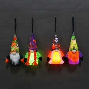 Set of four glowing Halloween gnome ornaments with pumpkin and skull patterns for decor