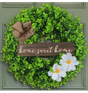 Decorative eucalyptus wreath for front door featuring a wooden home sweet home sign