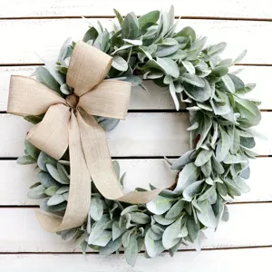 Macro view of artificial lamb's ear wreath featuring a rustic tan burlap bow decoration