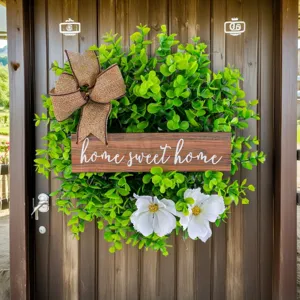Decorative fresh eucalyptus wreath with home sweet home wooden sign and white floral accents