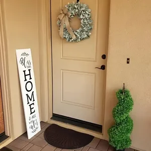 Detailed view of artificial lamb's ear wreath with burlap bow hanging on a home front door