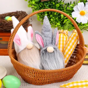 Gnomi pasquali di peluche con orecchie da coniglio in un cesto intrecciato per feste
