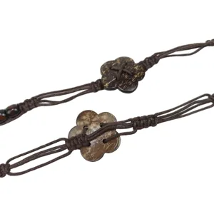 Handmade bohemian braided waist chain with natural coconut shell flower accents for women