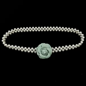 Elegant French camellia pearl elastic waist chain featuring a green flower for dresses