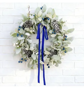 Macro view of artificial lamb's ear wreath with pinecones, berries and blue velvet ribbon
