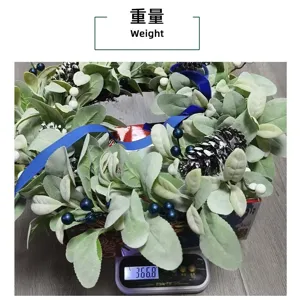 Artificial rabbit ear grass and pine cone wreath weighing 366.8 grams on a scale