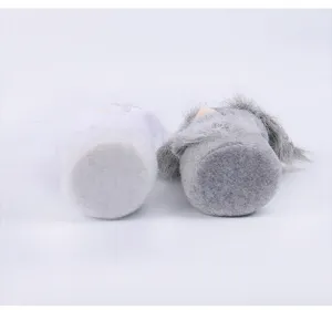 Detailed view showing the stable flat felt bottom of two plush Easter gnome decorations