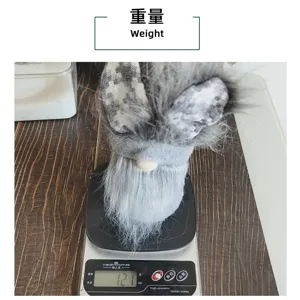 Macro view of a cute Easter bunny gnome doll being weighed at 121g on a kitchen scale