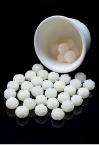 Close-up of finely carved white Bodhi root lotus beads on reflective black surface