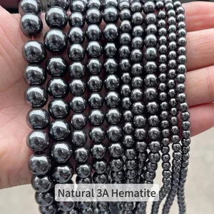Primo piano di perle in ematite naturale 3A di varie dimensioni per fai da te