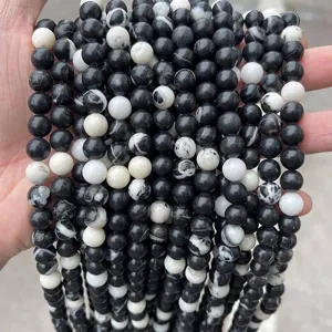 Detailed view of natural black and white zebra stone round beads for DIY jewelry making