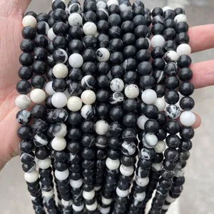 Macro view showing the natural black and white textures of zebra stone round beads