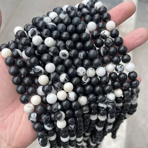 Close-up of natural black and white zebra jasper round loose beads for DIY jewelry