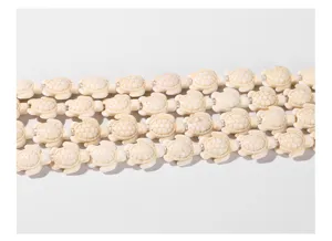 Detailed macro view of cream turtle shaped synthetic turquoise beads for DIY jewelry making