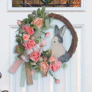 Easter grapevine wreath with pink roses, decorative ribbons and bunny silhouette for door