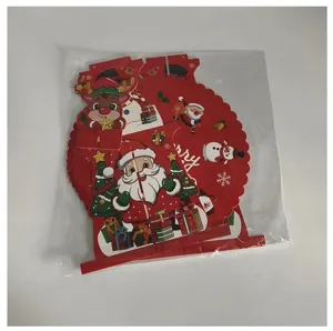 Detailed view of 3D Christmas themed paper cake stand decorations in plastic packaging