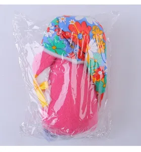 Festive pink plush gnome doll with sunflower floral hat in clear plastic packaging