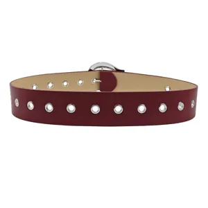 Stylish wide burgundy PU leather belt featuring silver grommet eyelets for women