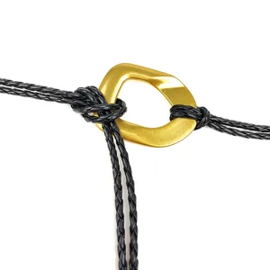 Macro view of a handmade braided black leather waist rope with a golden buckle