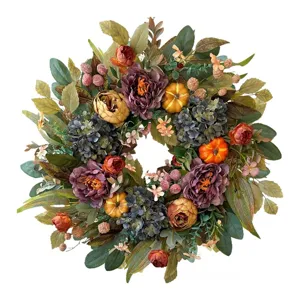Autumn floral wreath with pumpkins and berries for harvest festival door decoration