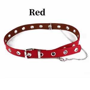 Stylish red Y2K faux leather belt featuring silver grommets and a dangling chain for jeans