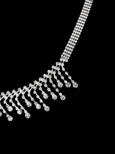 Close-up of belly dance waist chain with silver tassels and sparkling rhinestone details