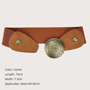 Vintage wide elastic corset belt with an ornate round bronze buckle in camel color