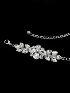 Close-up detail of elegant silver chain belt featuring sparkling rhinestone clusters
