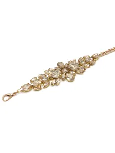 Macro view of sparkling champagne rhinestone flower motifs on a gold-toned waist chain belt