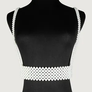 Close-up detail of an elegant white pearl suspender belt accessory for fashion layering