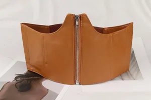 Detailed macro view of stylish brown faux leather wide corset belt with silver front zipper closure