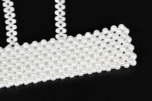 Detailed view of the elegant woven pearl strap with high gloss finish
