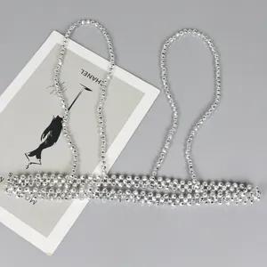 Detailed view of a silver beaded body chain harness accessory for dresses and shirts