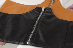 Close-up detail of faux leather corset belt with front zipper and boning texture.