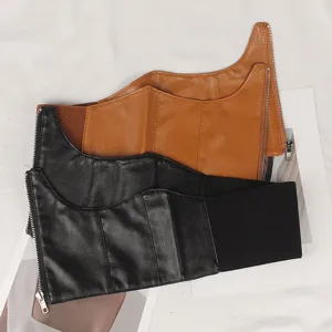 Detailed view of wide elastic corset belts in black and brown with zipper and fishbone
