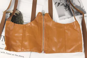 Detailed macro view of a brown PU leather corset belt with front zipper and straps.