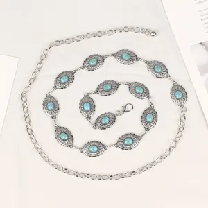 Detailed view of bohemian silver metal waist chain with oval turquoise stone settings