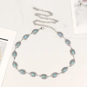 Close-up of vintage silver metal waist chain belt with blue turquoise stones
